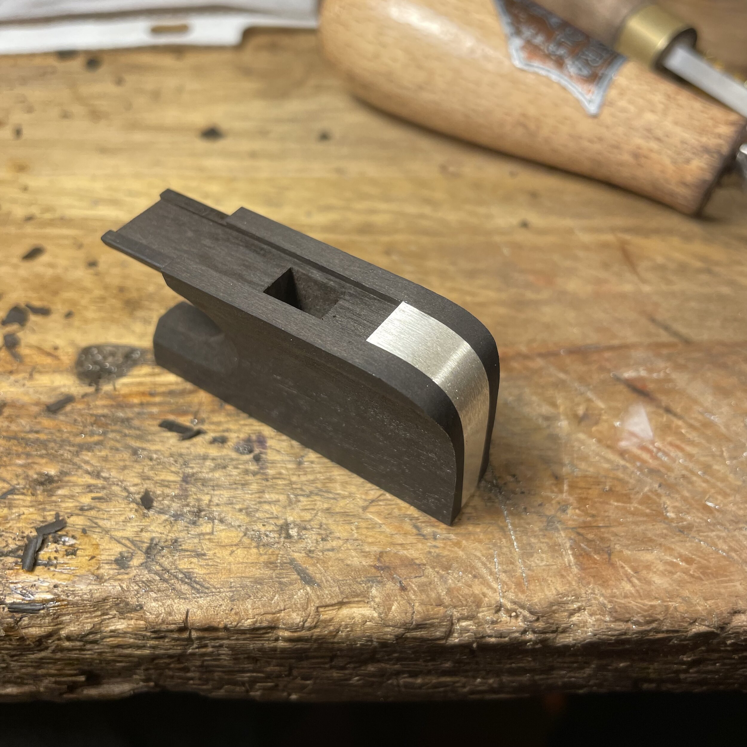 The rounded cello heel plate is then bent and placed in the channel. This will be secured with a few silver pins. At this point the frog mortise that will hold the hair and wedge is also carved out.