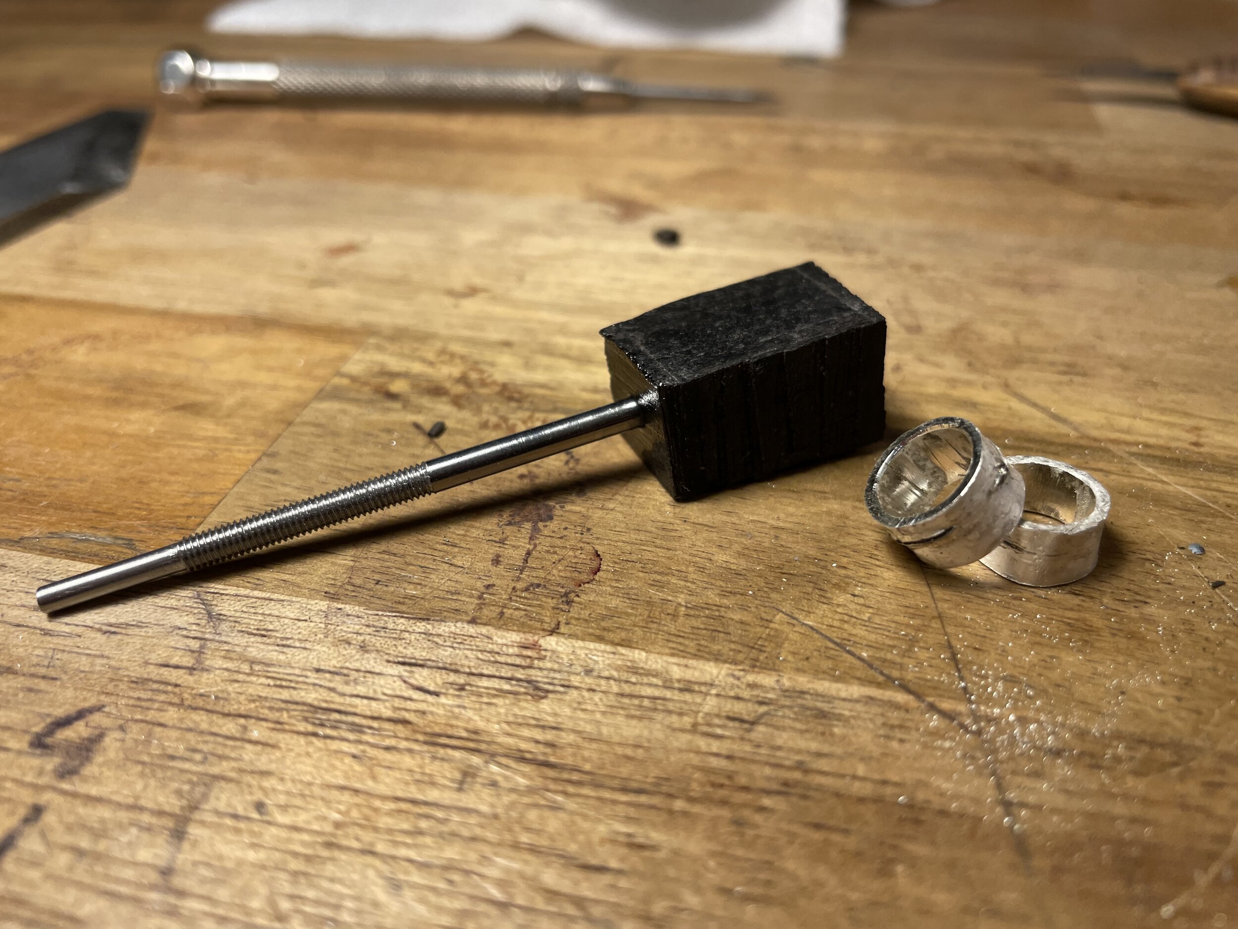 A piece of ebony is then picked out and fastened onto the screw to start our button.