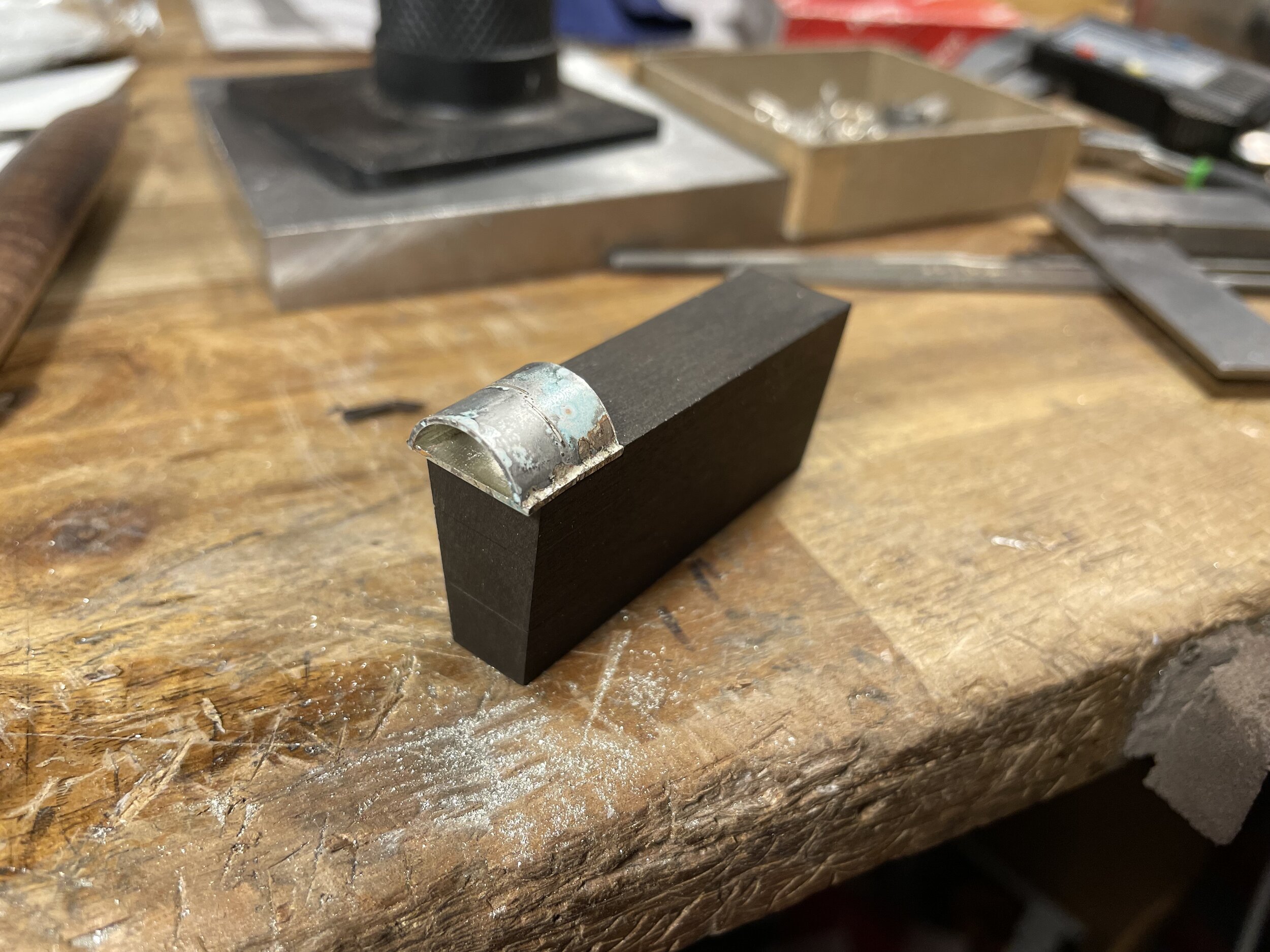 Setting aside the stick I then begin to make the frog. After soldering together the sterling silver ferrule I pick a piece of ebony to make the frog.