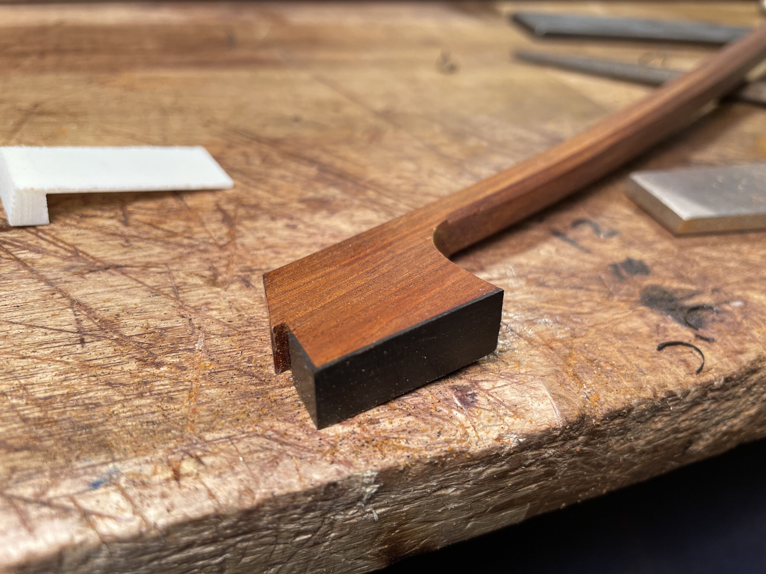 Next, I create the shape and side angles of the tip and put on the ebony liner and tip plate.&nbsp; For this cello bow I used a Tip Armor tip plate which is made from epoxy and cotton. It is a very durable material and due to the weaved pattern can