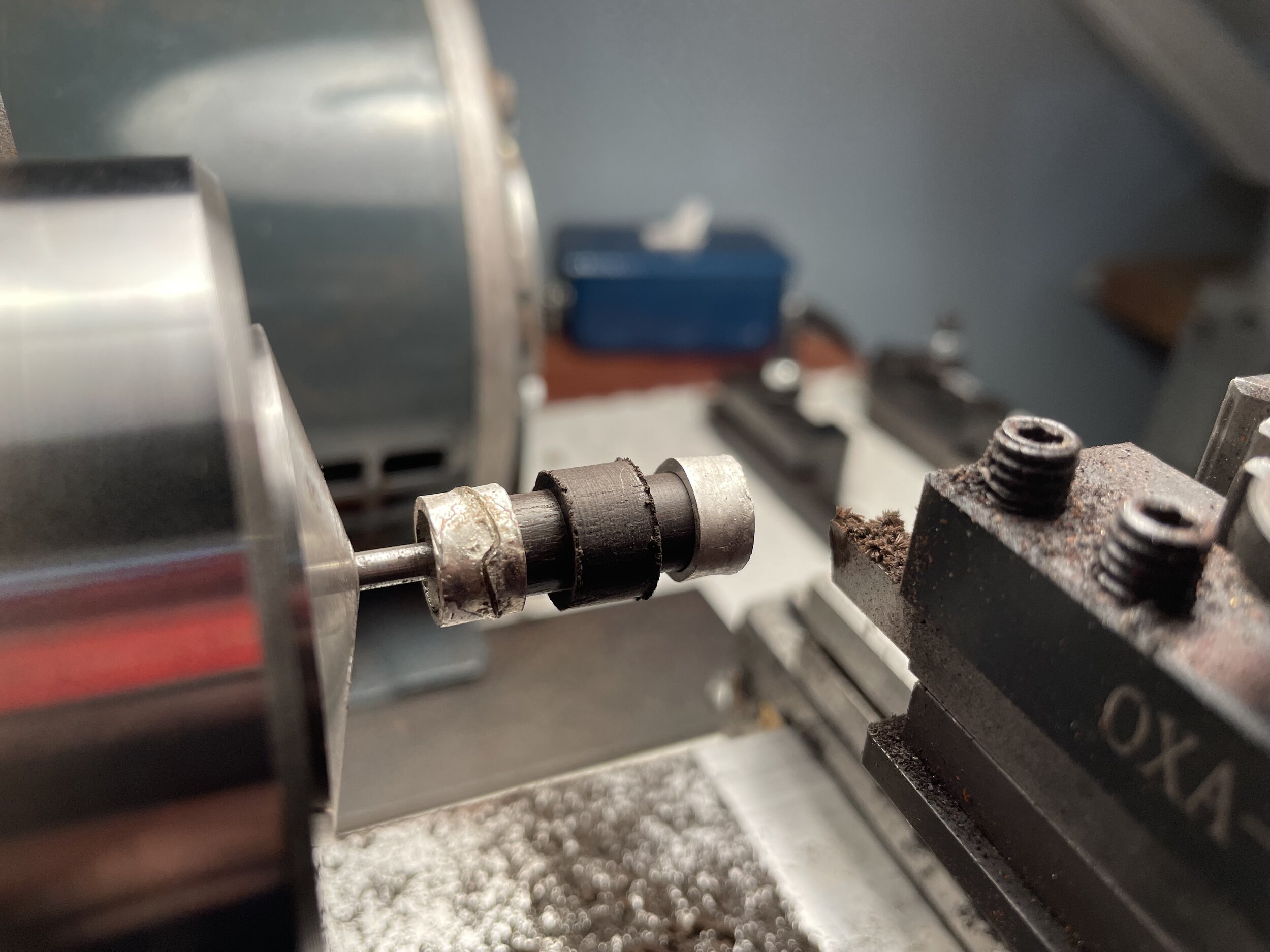 We go back to the lathe to turn the ebony down until it fits our rings. After that the rings are glued and pinned in and the button is turned once more to round everything and turn the collar at the base of the button.&nbsp;&nbsp;