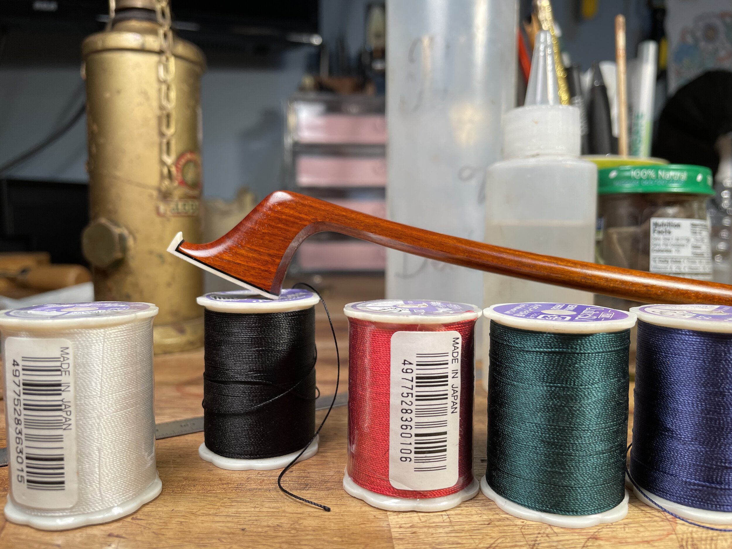 We then choose the winding that will best match the color of our stick. I chose green for this one to compliment the nice red hue of the pernambuco. Different kinds of windings can be used to adjust the balance point. I would use a heavier silver wr